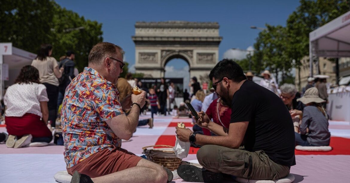 Paris' famous Champs-Elysees turned into a mass picnic blanket for an unusual meal