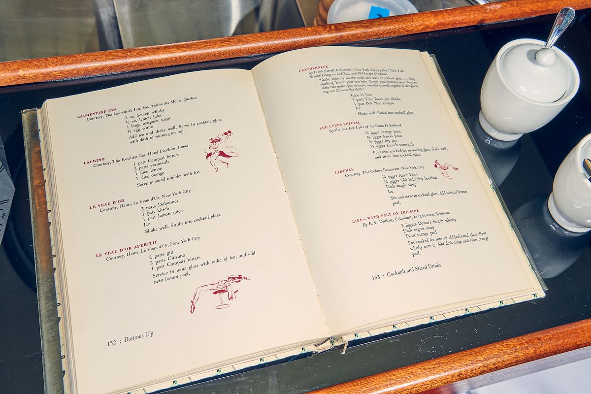 A cocktail recipe book behind the bar at Le Veau d’Or. 