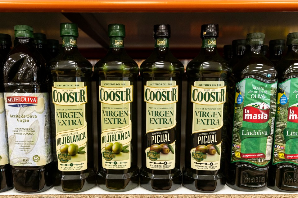 Shelf of various olive oil bottles.