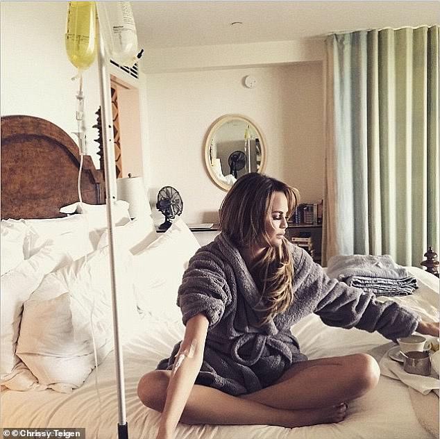 Model Chrissy Teigen posted this image of her using an IV drip on Instagram in 2015 and wrote: 'Hello body meet vitamins'