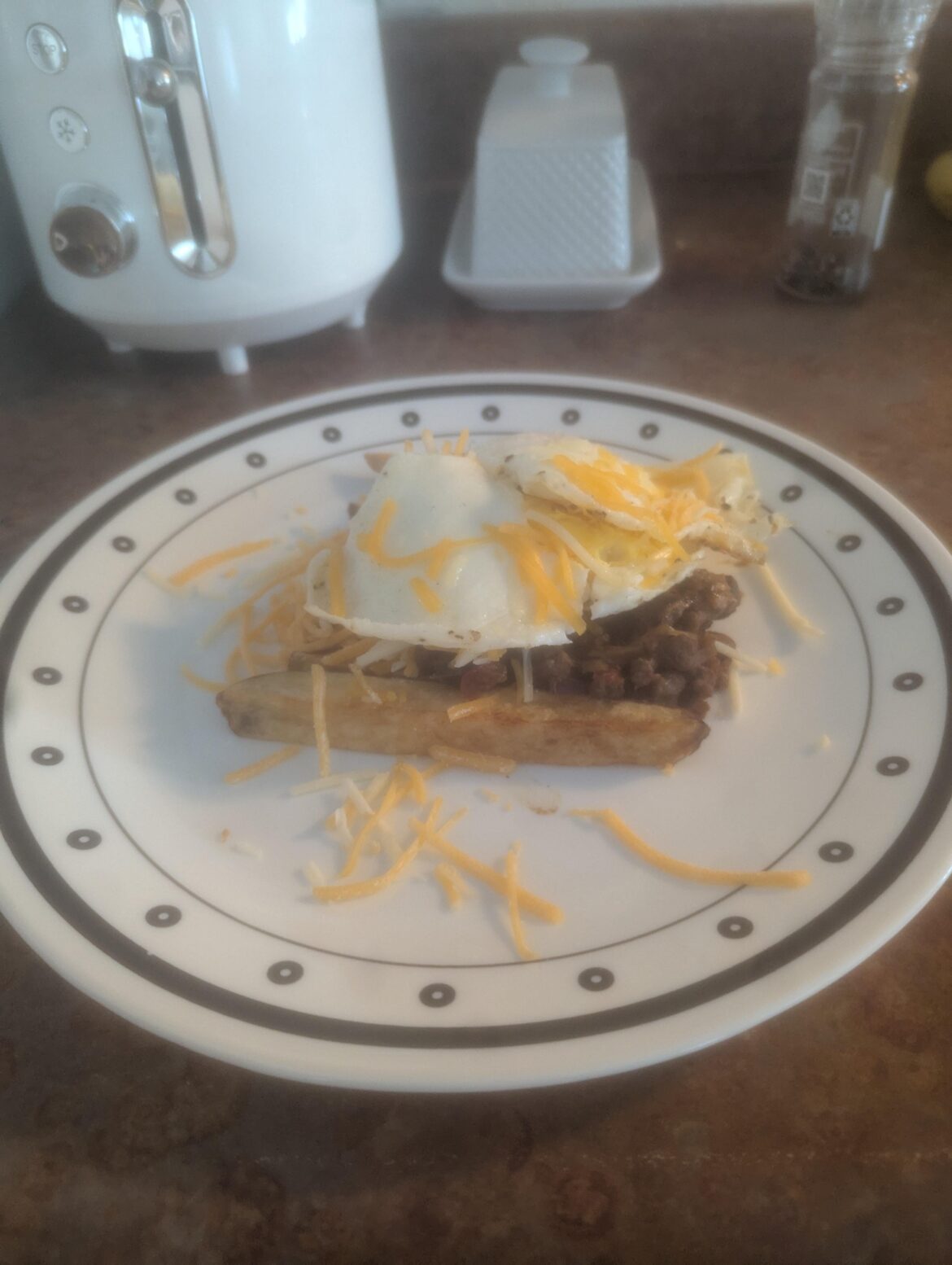 My boyfriend made breakfast! Chili cheese fries with overhard eggs!