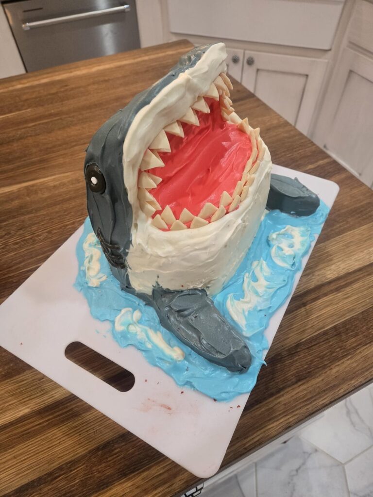 I made a shark cake with a surprise center for my kids birthday! First time carving cake and I am pretty happy with it!