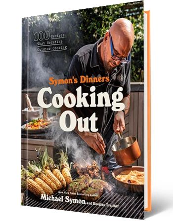 the cover of michael symon's new cookbook "symon's dinners cooking out: 100 recipes that redefine outdoor cooking"
