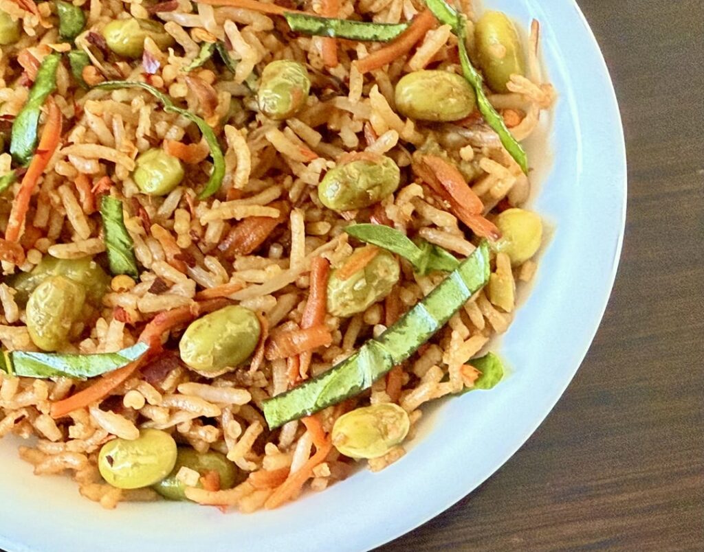 Fried Rice With Edamame, shredded carrots, sliced sweet basil leaves, crushed fresh garlic, and dark soy sauce.