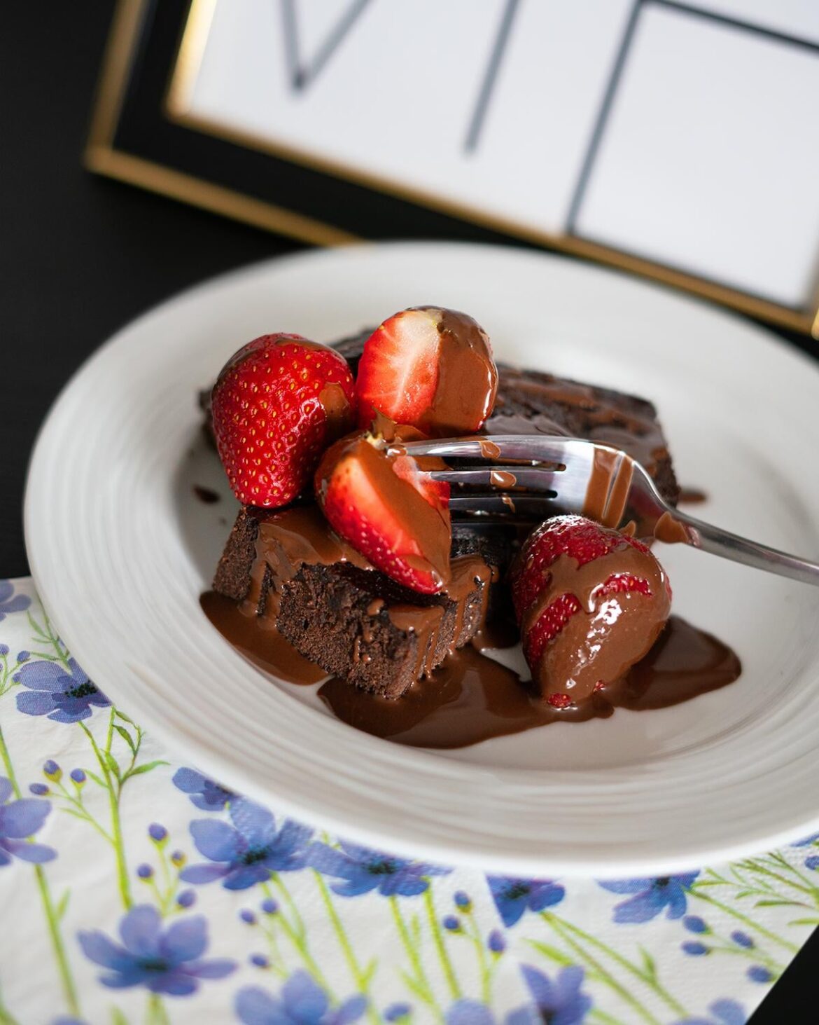 Homemade brownie with fresh strawberries and chocolate sauce