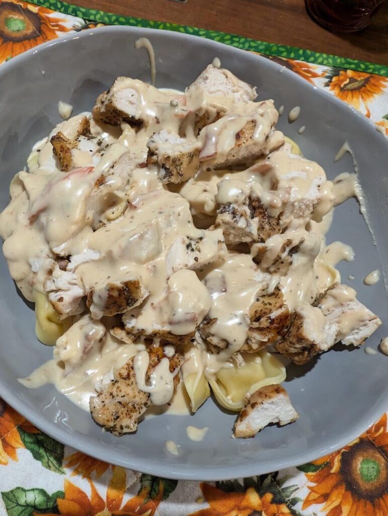 Chicken breast with tortellini and a bacon tomato Alfredo sauce