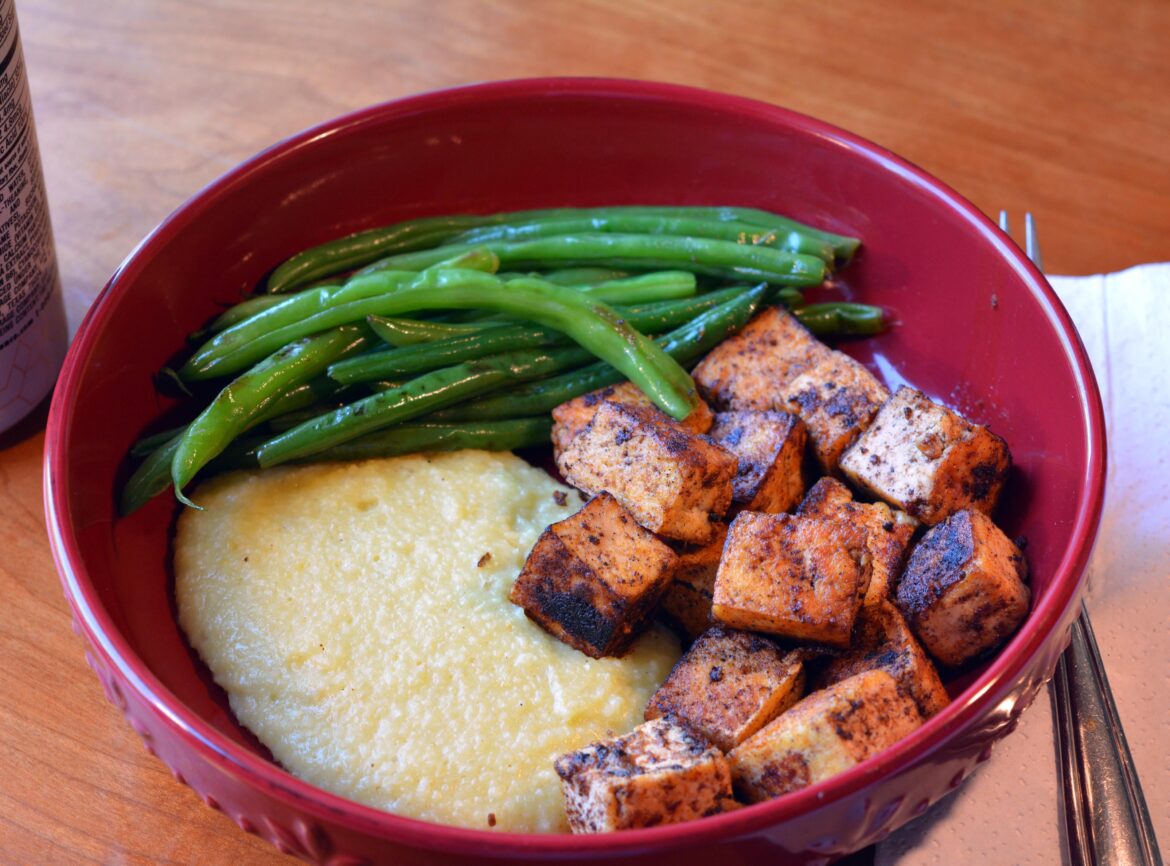 Blackened Cajun tofu, cheesy grits, and green beans. 332 cal, 26 g protein