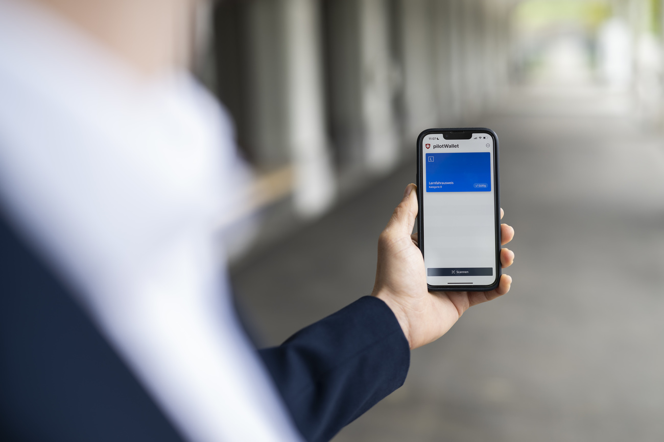 Photo of a man holding a phone with virtual wallet