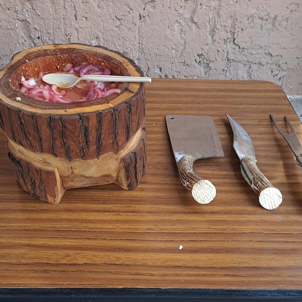 Making salsa in wood molcajete