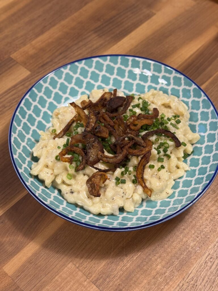 Käsespätzle and Buchteln filled with plum jam and vanilla sauce