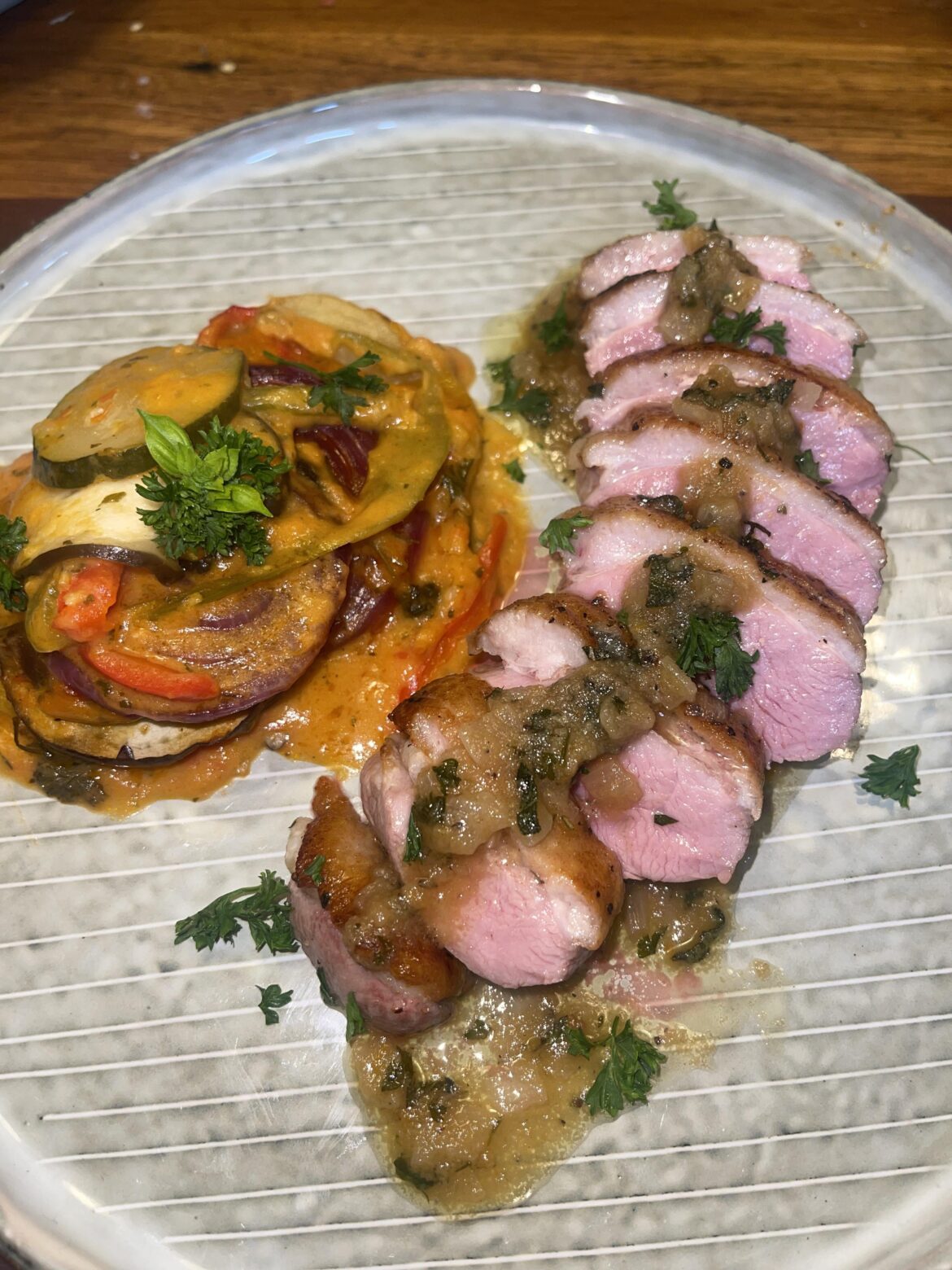 Pan seared duck with an orange pan sauce served with ratatouille