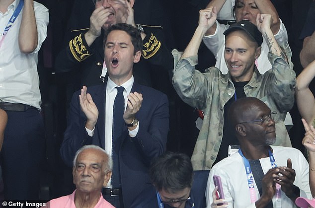 French Prime Minister Gabriel Attal cheered Marchand onto his first Olympic gold