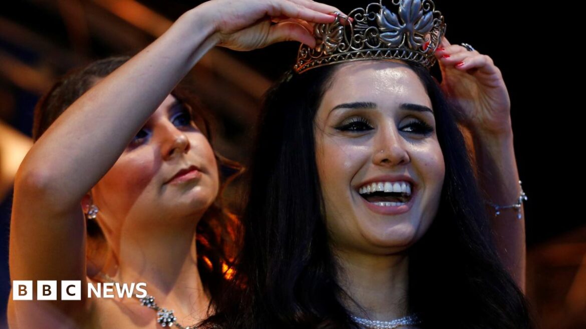 Syrian refugee Ninorta Bahno receives crown during ceremony for the new wine queen in Trier, Germany, August 3, 2016