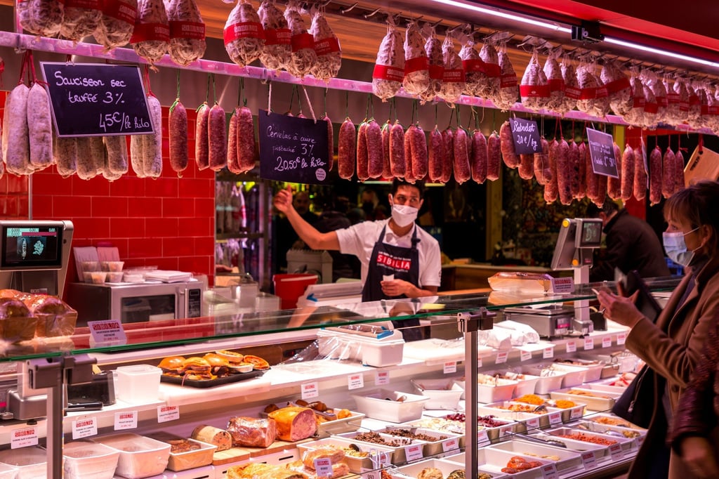 A worker sells gourmet food at the Halles de Lyon Paul Bocuse, in Lyon, France. Photo: Shutterstock