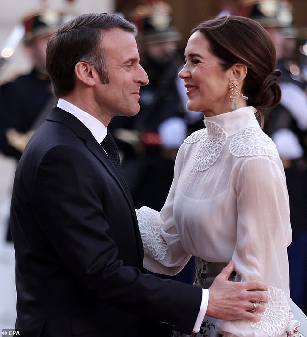 Emmanuel and Mary warmly embraced each other before entering the state dinner on Monday evening