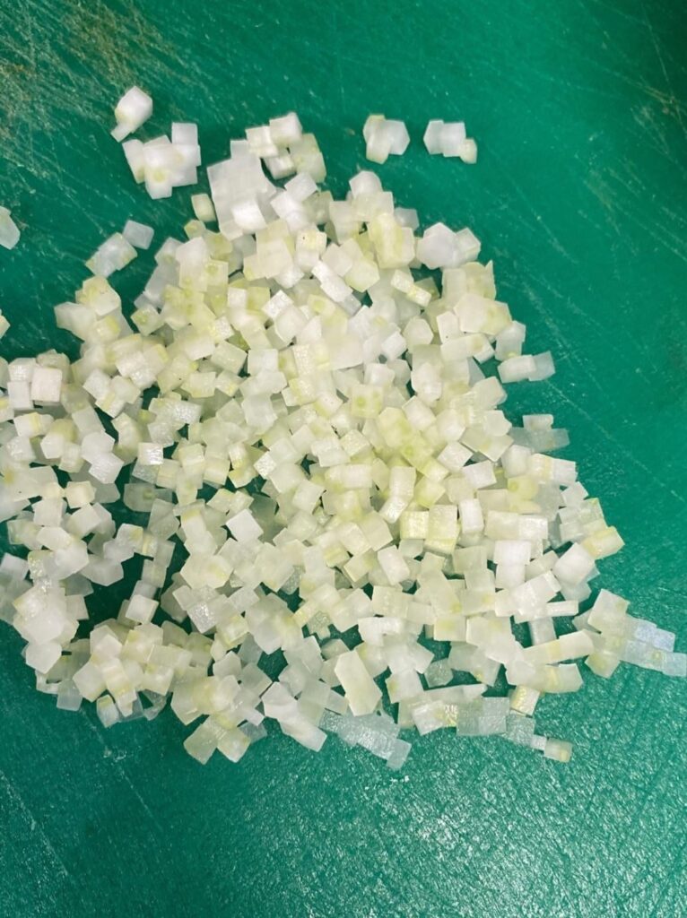 Teaching the apprentice the basic knife cuts. Brunoise.