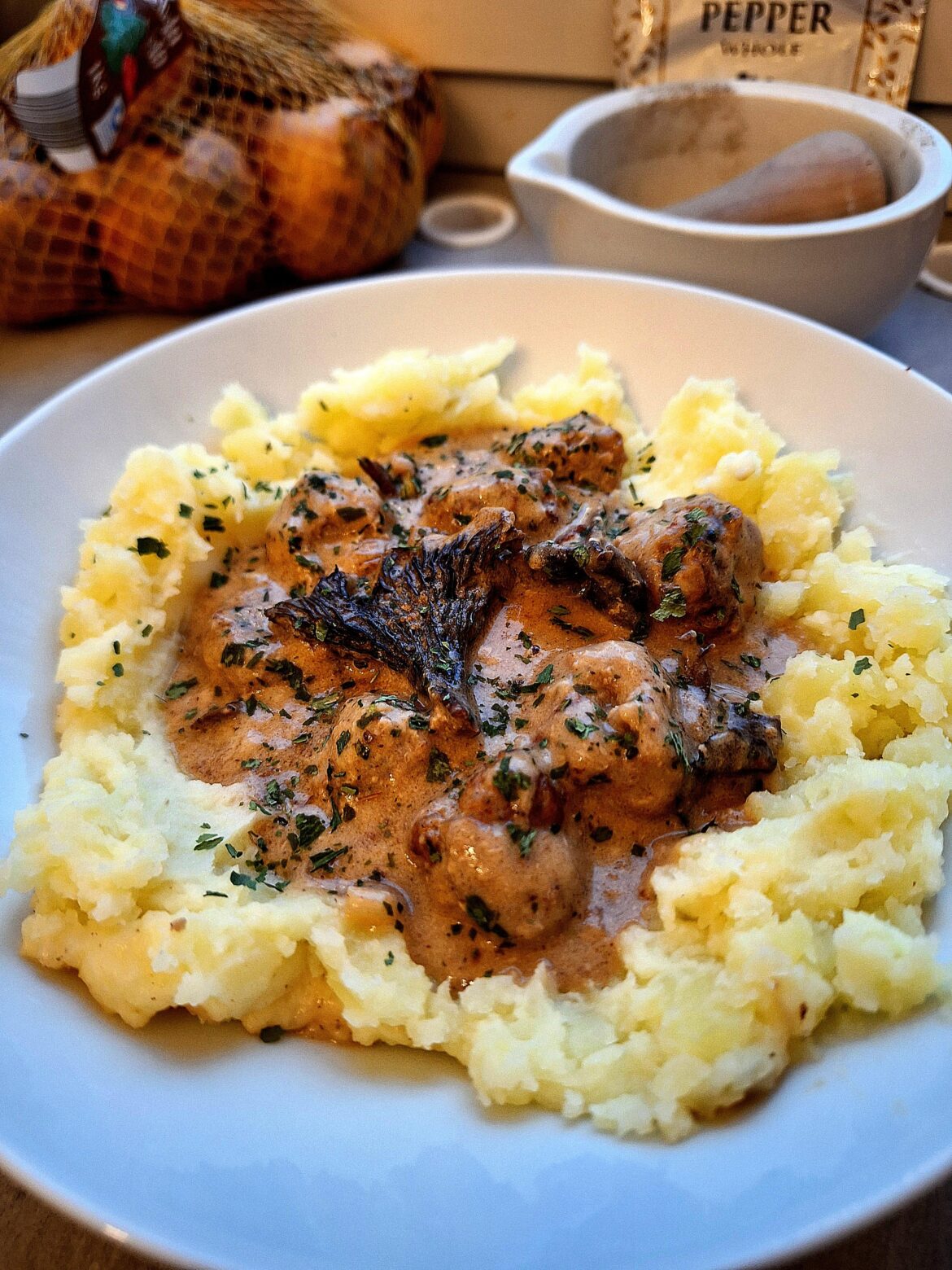 Meatballs and black trumpet mushrooms in creamy brown sauce