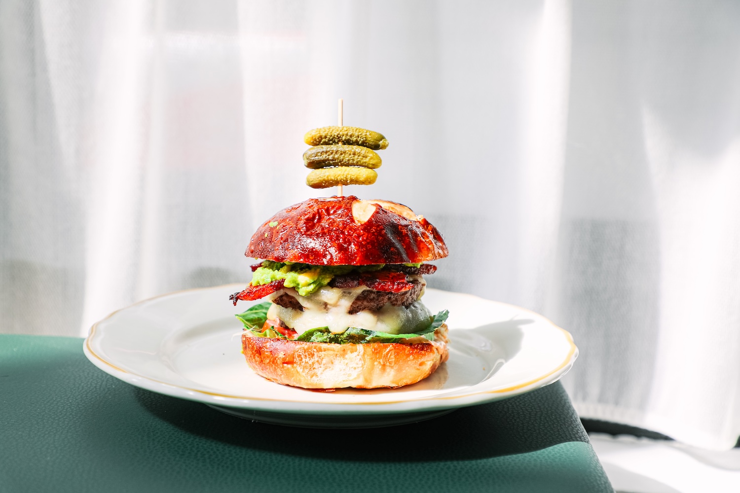 burger with three small stacked pickles