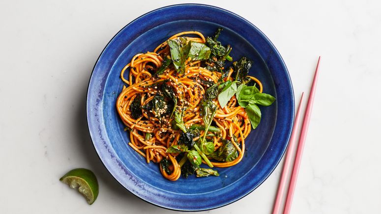 Gochujang sesame noodles with torn basil in a bowl