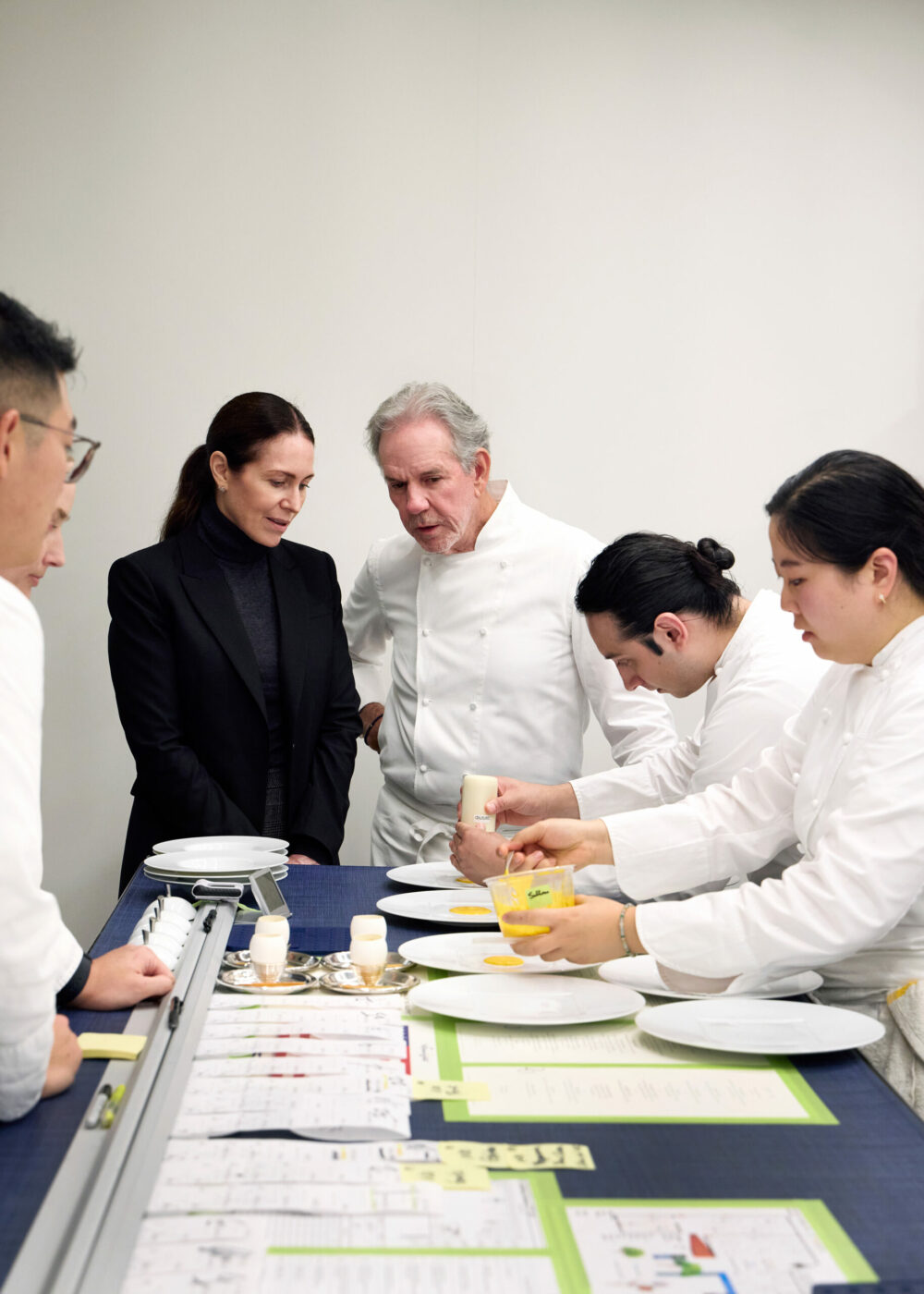 Laura Cunningham, left, and the chef Thomas Keller, partners in the French Laundry and Per Se, in the kitchen of the French Laundry in Yountville, Calif., Nov. 20, 2024. As Thomas Keller's most influential restaurants hit major birthdays, the cost and the demand have risen. (Aya Brackett/The New York Times)