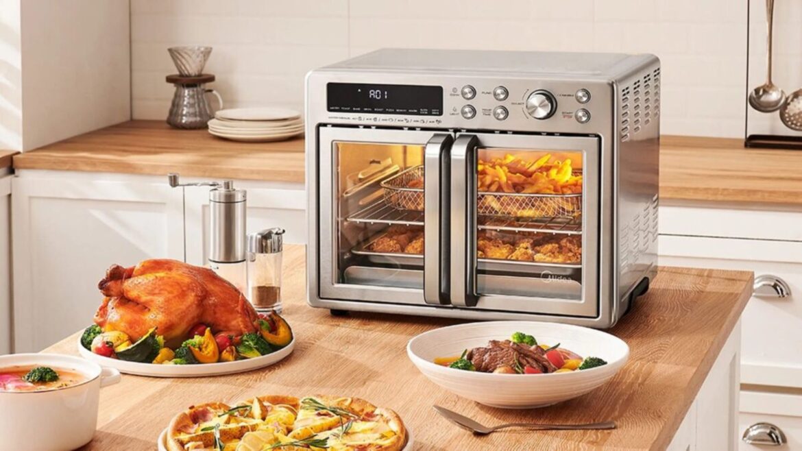 Are French door air fryers worth it? A Midea Flexify French Door Air Fryer Oven cooking an entire meal on a kitchen counter