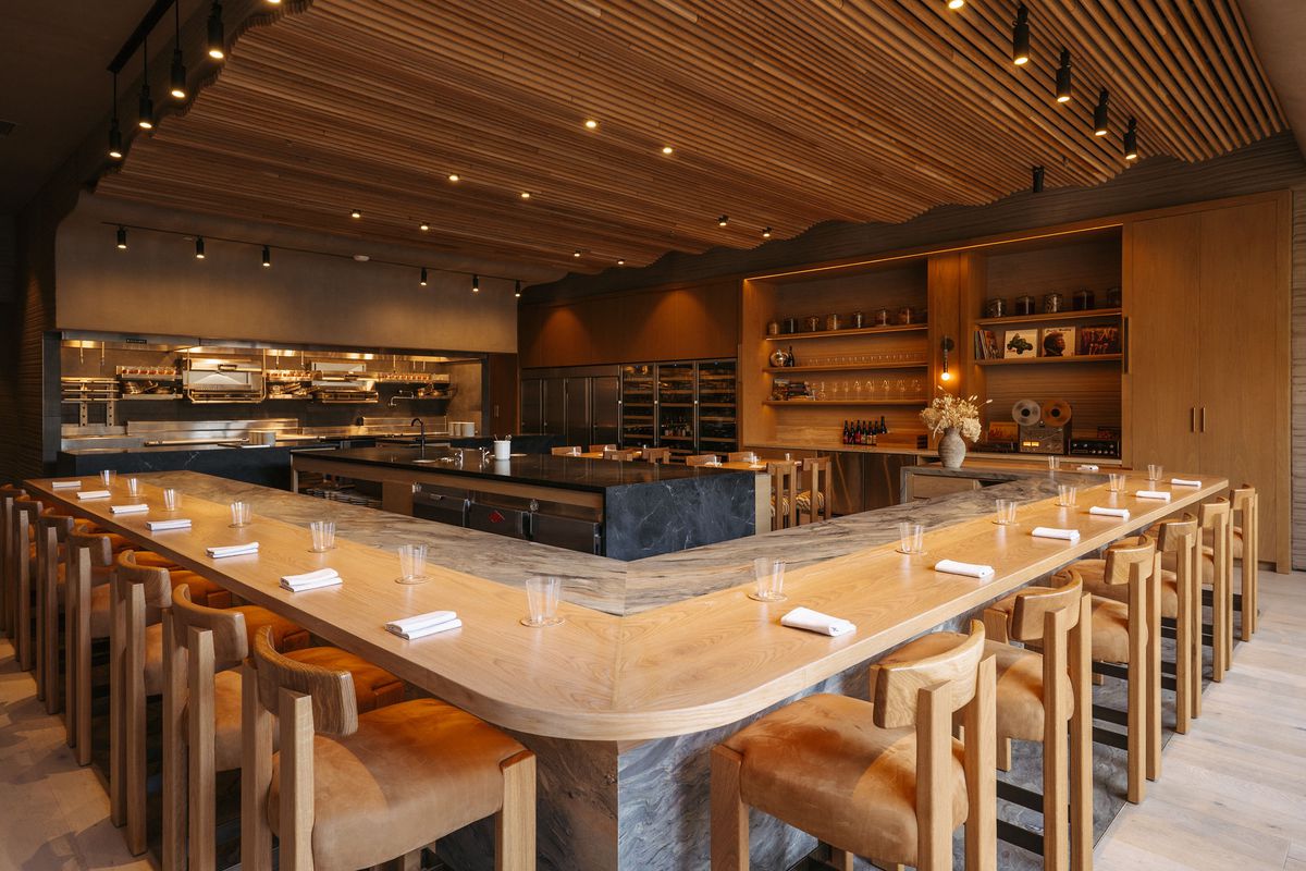 A dining room with wood panels and counters.