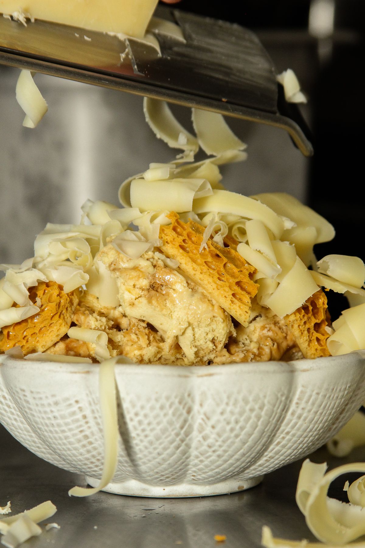 Comté cheese is freshly grated on top of the famous honey semifreddo