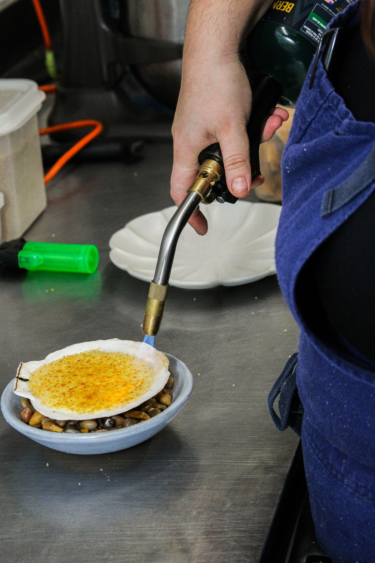 A custard is torched in the Lutèce kitchen