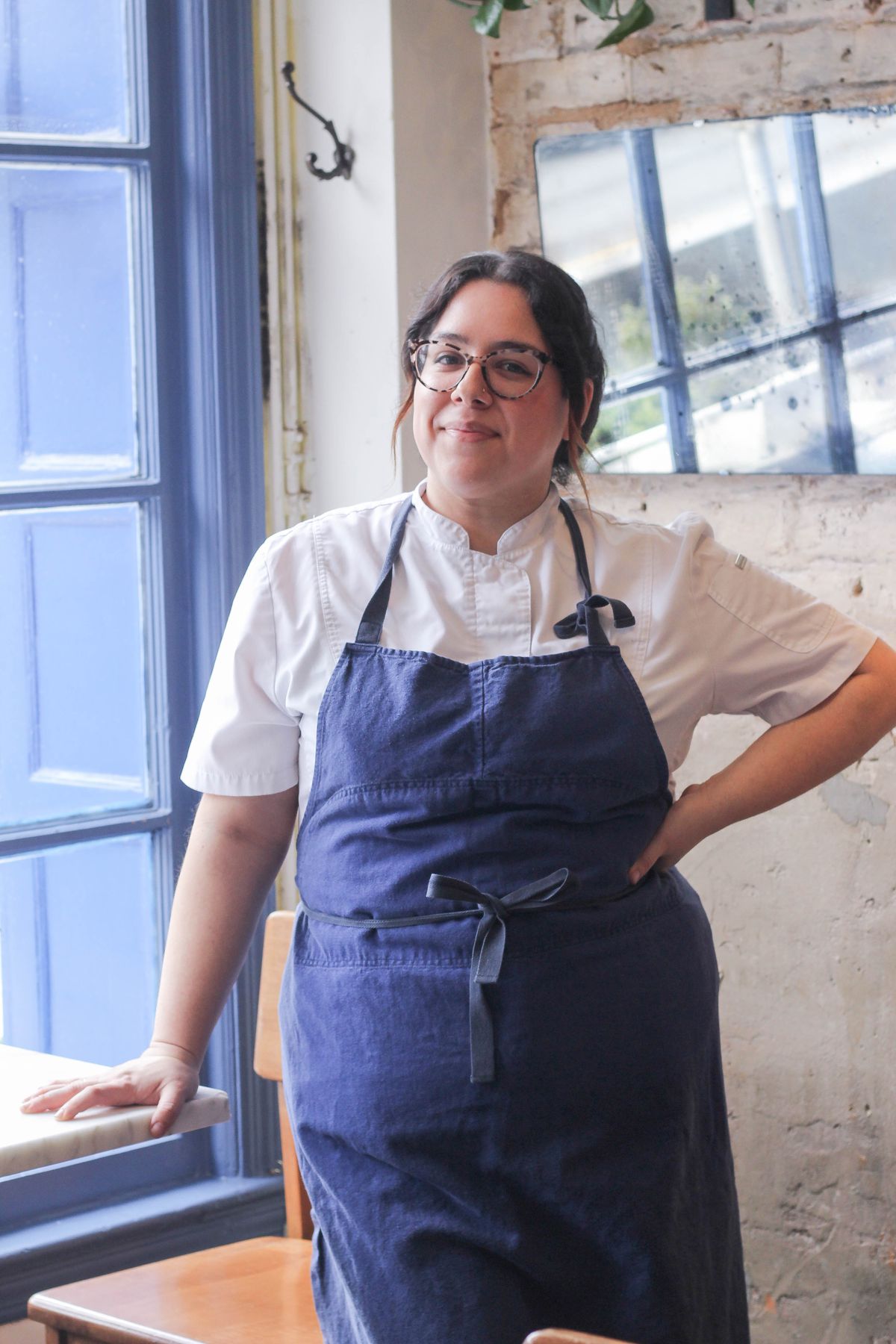 Chef Ana Sofía Pino leans against a table in the Lutèce dining room.