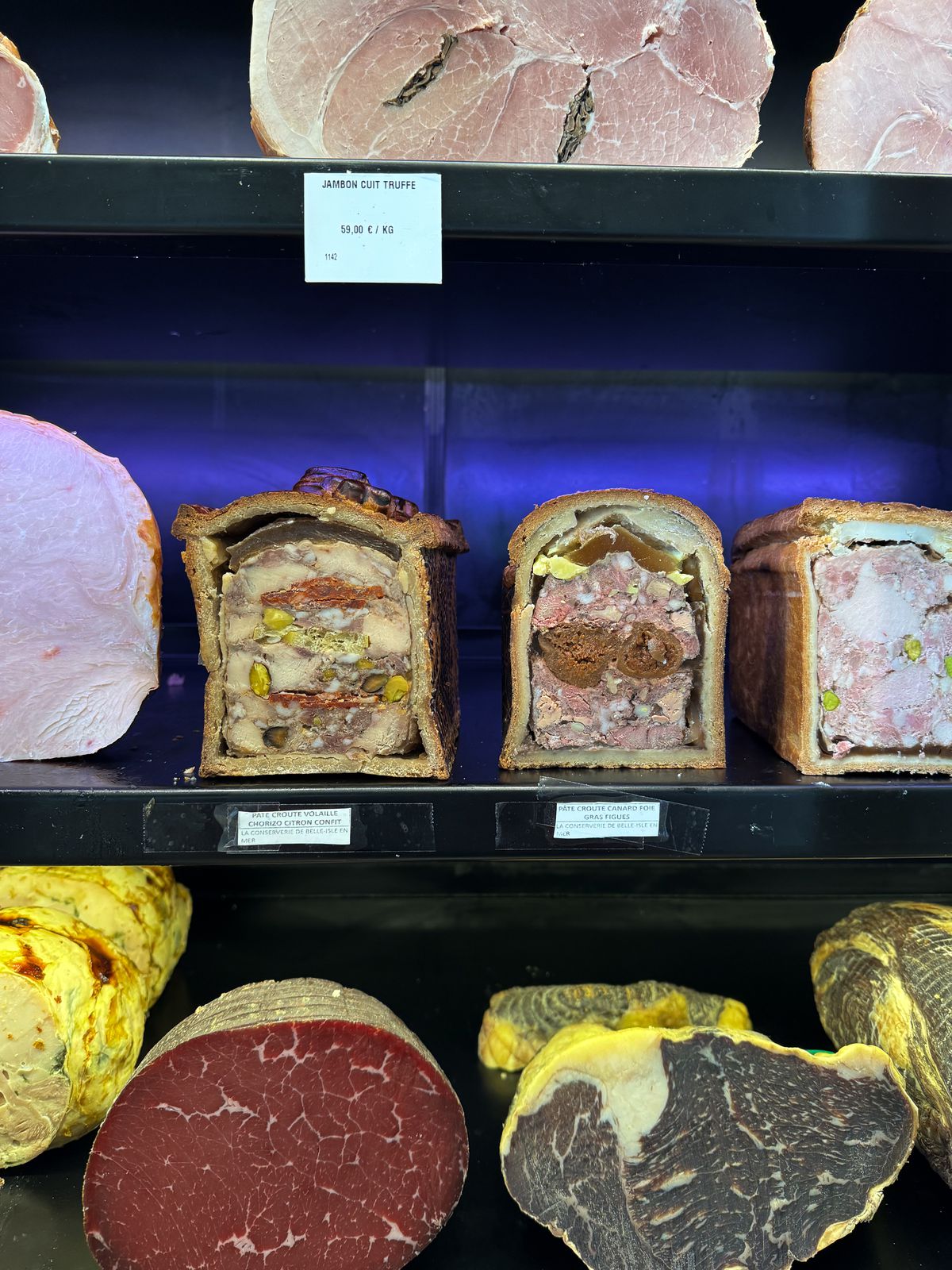 Shelves of terrines and cured meats.