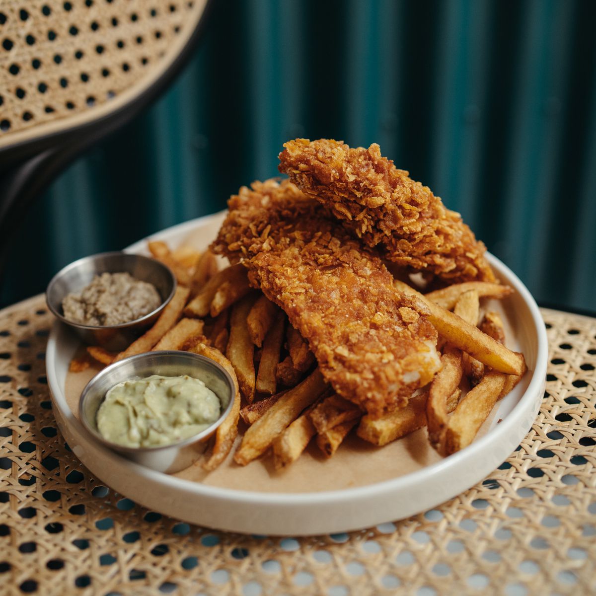Fried fish and french fries with dipping sauces.