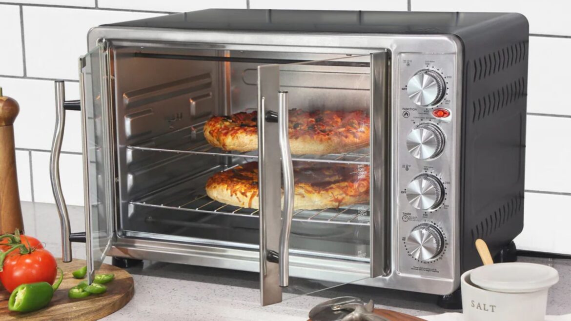 Elite Gourmet Double Door Oven: a big, cheap toaster oven An Elite Gourmet French Door Convection Toaster Oven cooking two pizzas on a white kitchen countertop