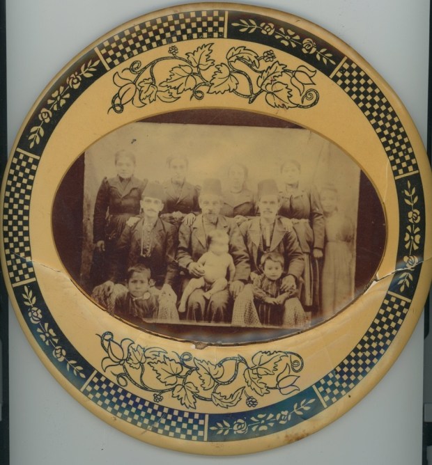 A plate with some survivors of the Armenian Genocide. Krikor Mirijanian (boy front right); Kevork Mirijanian (man sitting front center with boy on lap); father of Krikor Mirijanian; first name unknown Mirijanian (boy sitting on lap), son of Kevork Mirijanian, Sarkis Mirijanian (boy front left), older brother of Krikor Mirijanian and son of Kevork Mirijanian. Photo taken c. 1909-1910 in Arapkir, Turkey. Krikor and Sarkis survived the Armenian Genocide of 1915. Their younger brother, first name unknown, did not. (SALLY CRAGIN)