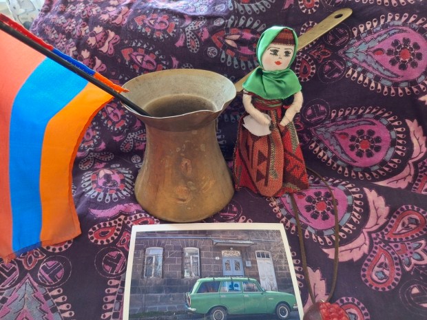 A "sourjamon," brass coffee-maker inherited by the author from her grandmother, alongside a doll from Armenia, and a photo of a Soviet-era Lada taken by the author's godson's sister. The pomegranate necklace is a real pomegranate, dried and made into jewelry. (SALLY CRAGIN)