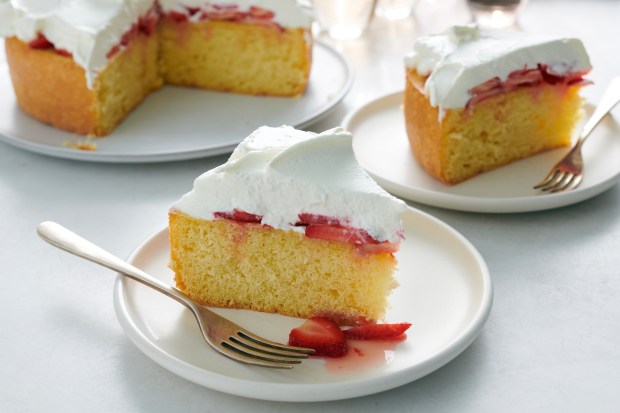 cake topped with strawberries and whipped cream