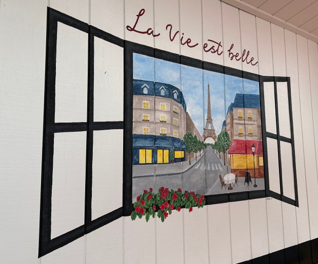 Artwork depicts a Paris street scene at Délices du Chef...