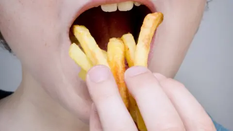 Getty Images person eating chips