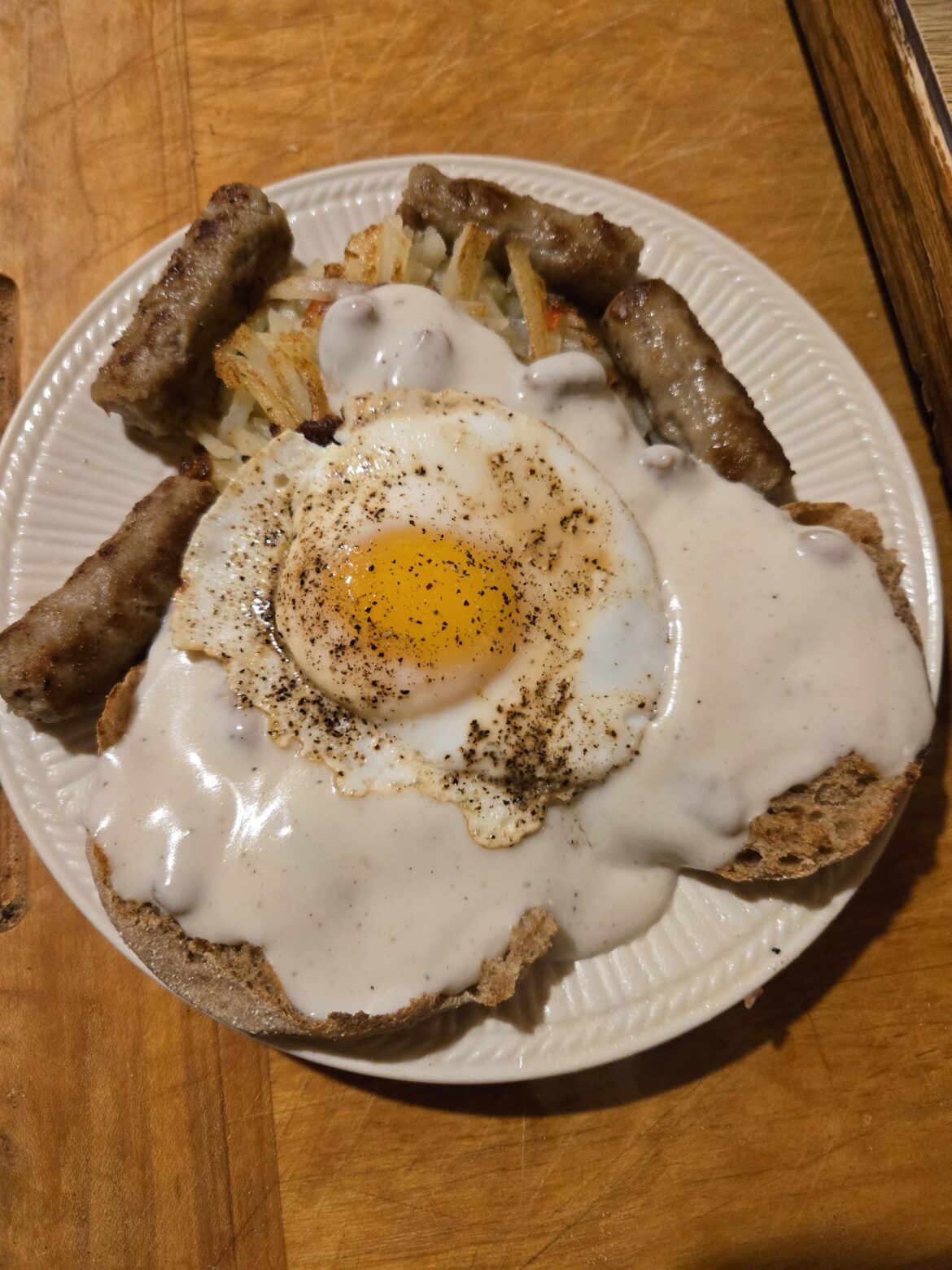 Duck egg on hashbrowns with biscuits and gravy