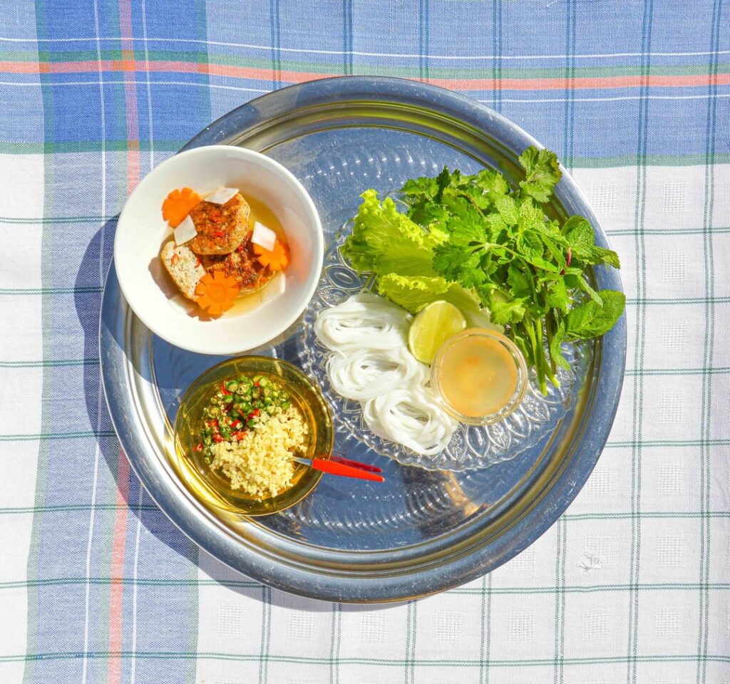 Bún chả - take on Vietnamese-style grilled turkey and prawn meatballs, served in a tangy sauce with rice vermicelli, a side of pickled kohlrabi and carrot, and fresh herbs
