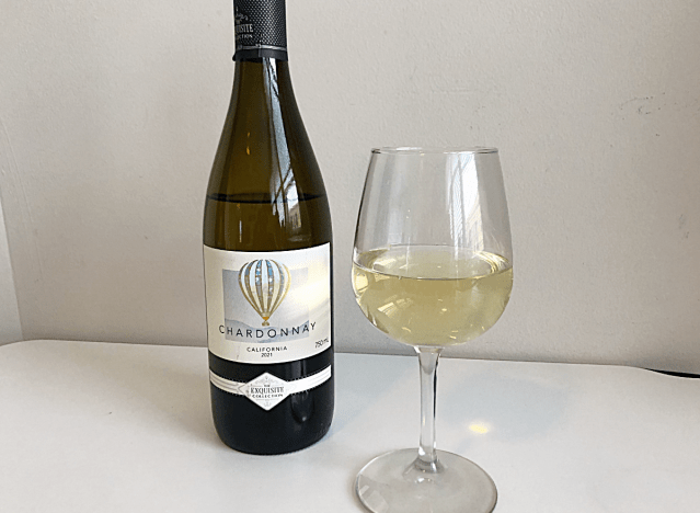 a bottle of chardonnay next to a glass of wine