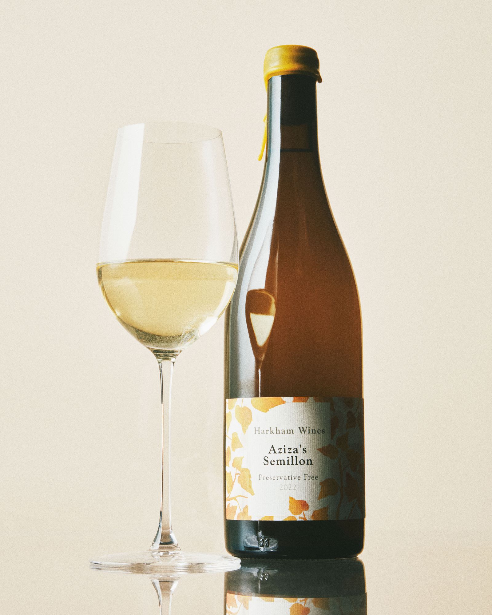 A glass and bottle of Harkham Wines Aziza's Semillon.