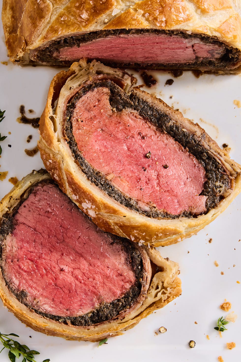 beef wellington sliced with fresh rosemary