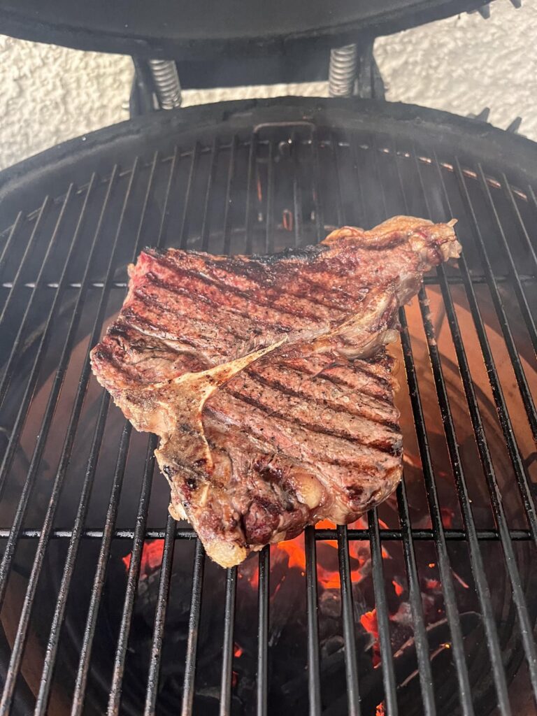 T-bone steak, chicken kebabs and sides.