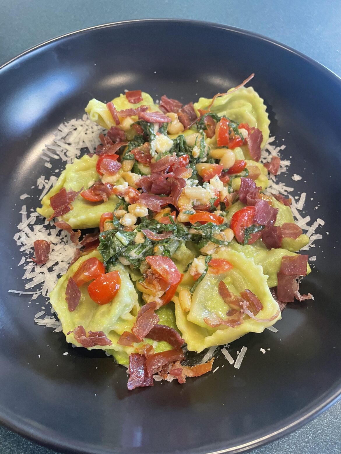 Tortellini in a pea cream sauce, topped with crispy prosciutto and caprese