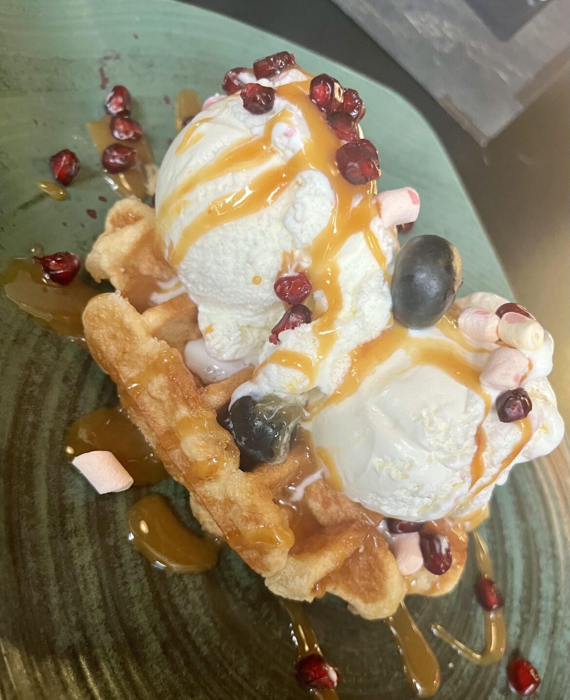Waffle with vanilla ice cream and salted caramel on top