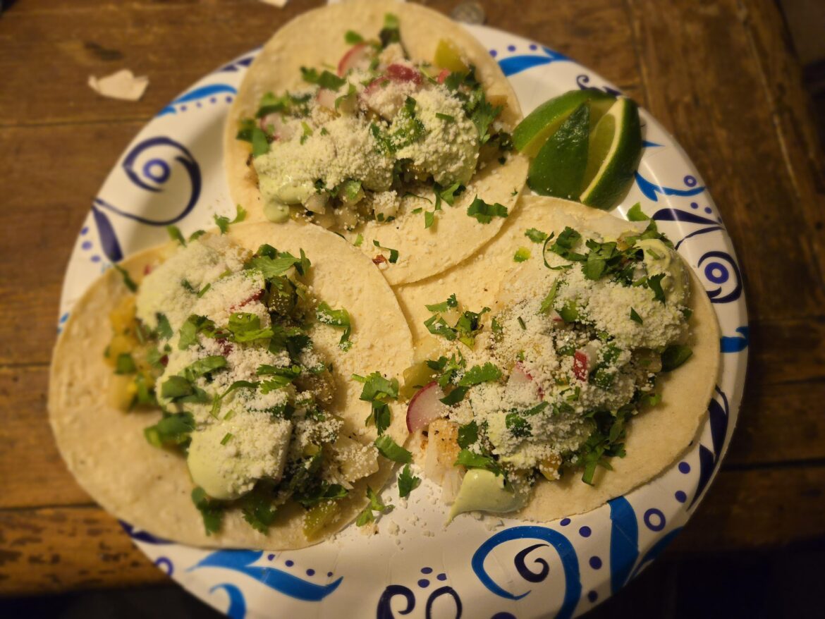 Cod tacos with pineapple tomatillo salsa, avocado cilantro lime crema and radish.