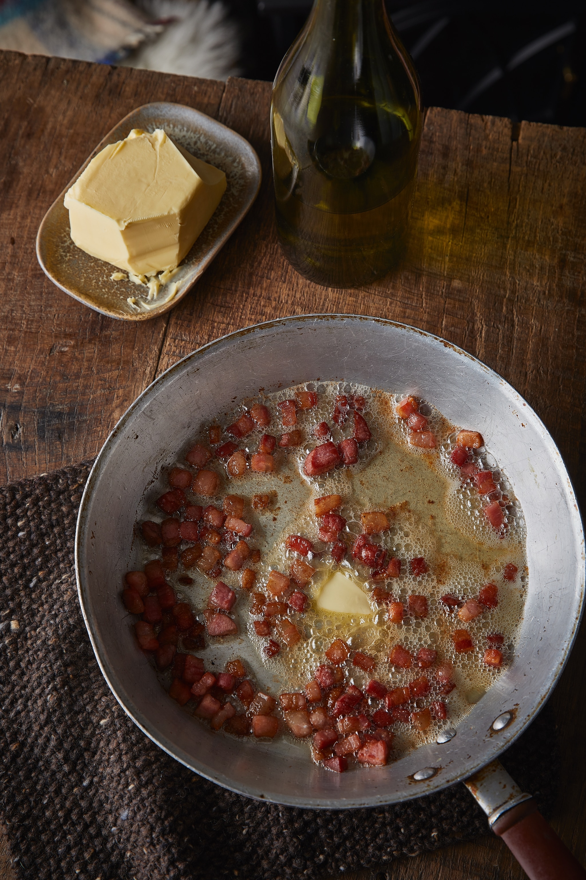 Lardons of bacon are fried in a generous amount of butter.