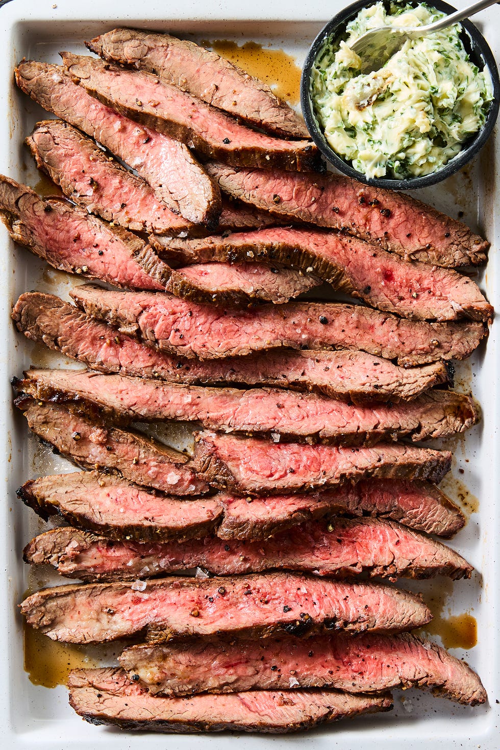 brown sugar and dijon marinated flank steak, broiled to medium rare, thinly sliced, and served with roasted garlic and herb butter