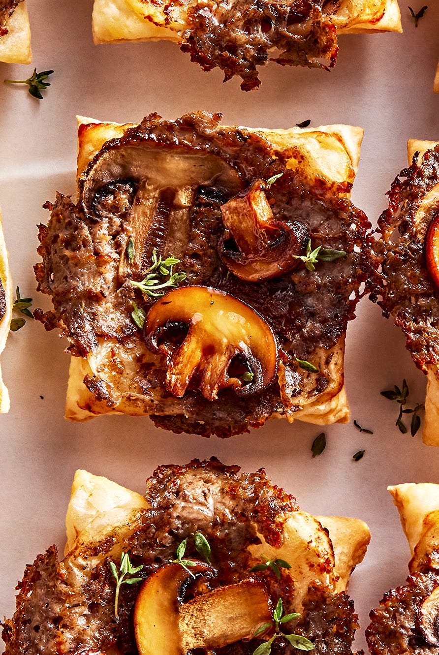 individual puff pastry squares topped with a cheesy mushroom duxelles, slices of roasted mushrooms, and fresh thyme