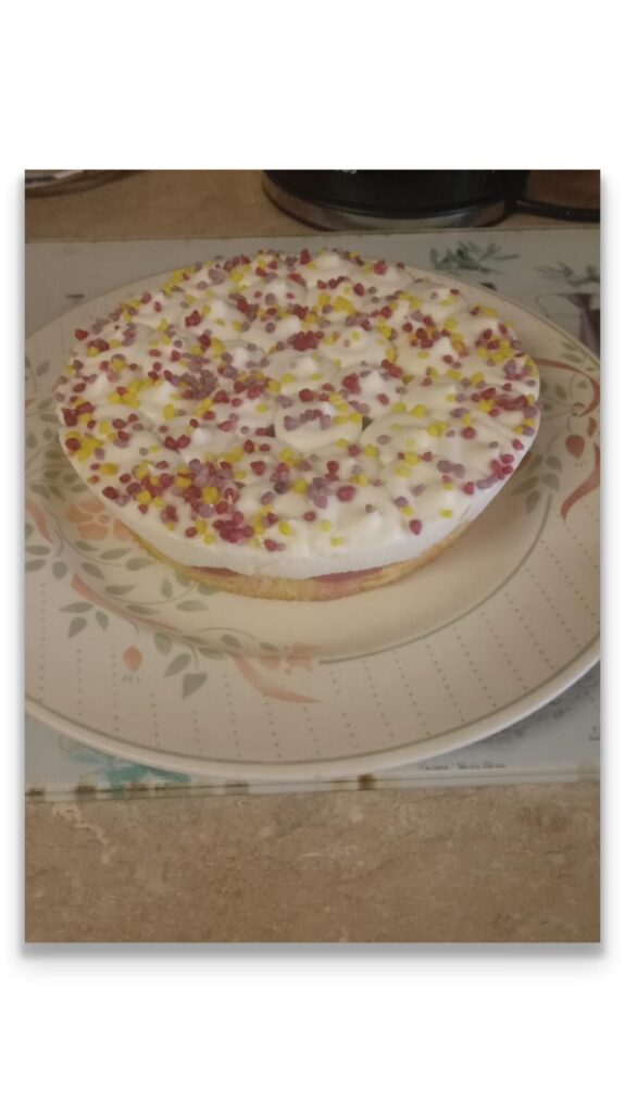 Sponge cake with strawberry mousse cream and sprinkles